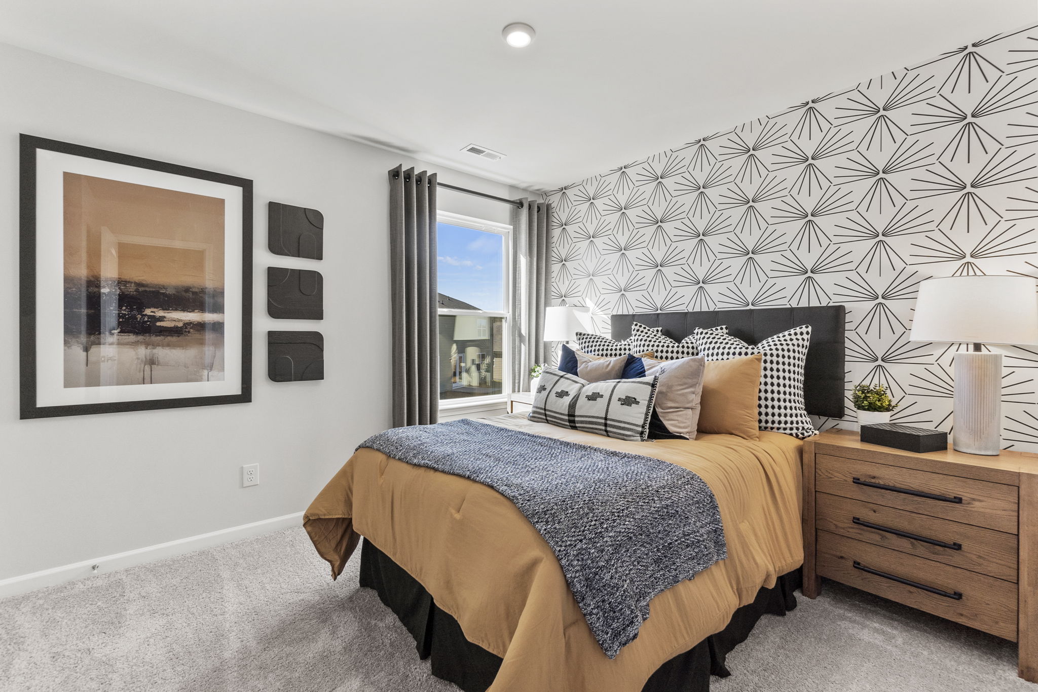 A bedroom with a bed and a window.