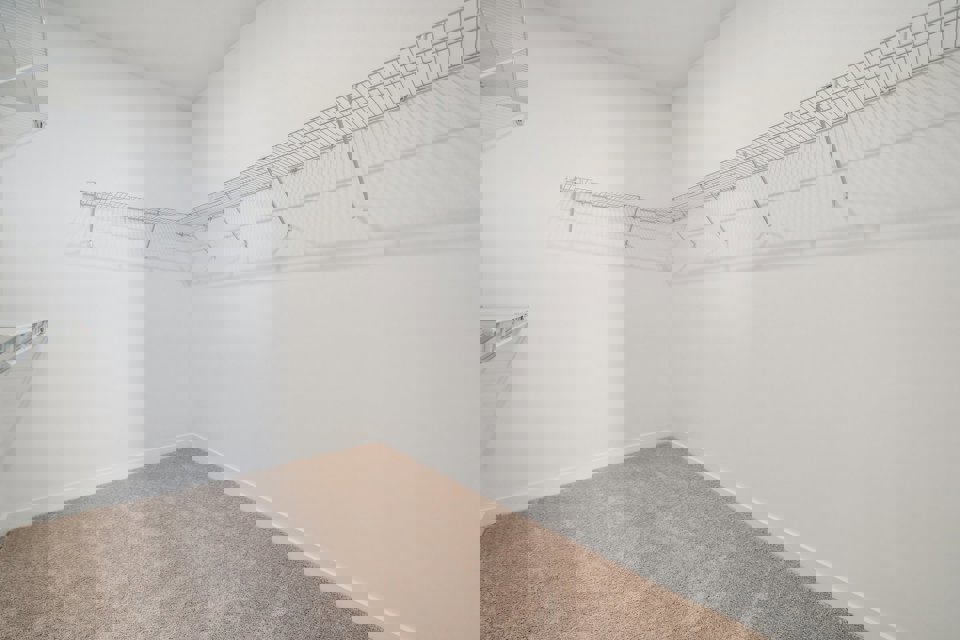 A white room with a carpet.