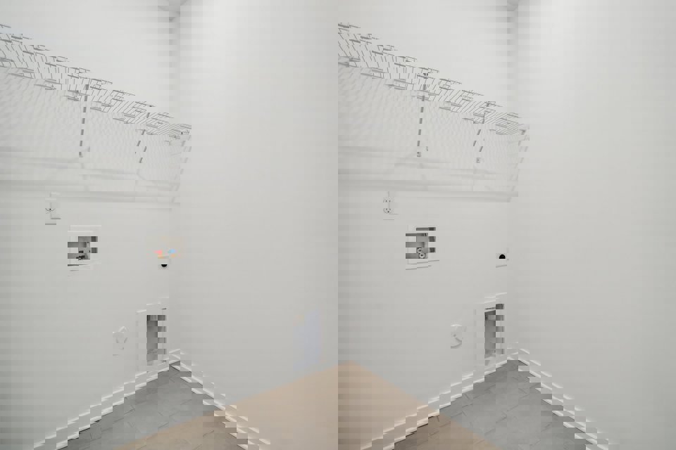 A white room with a tile floor and a white ceiling.