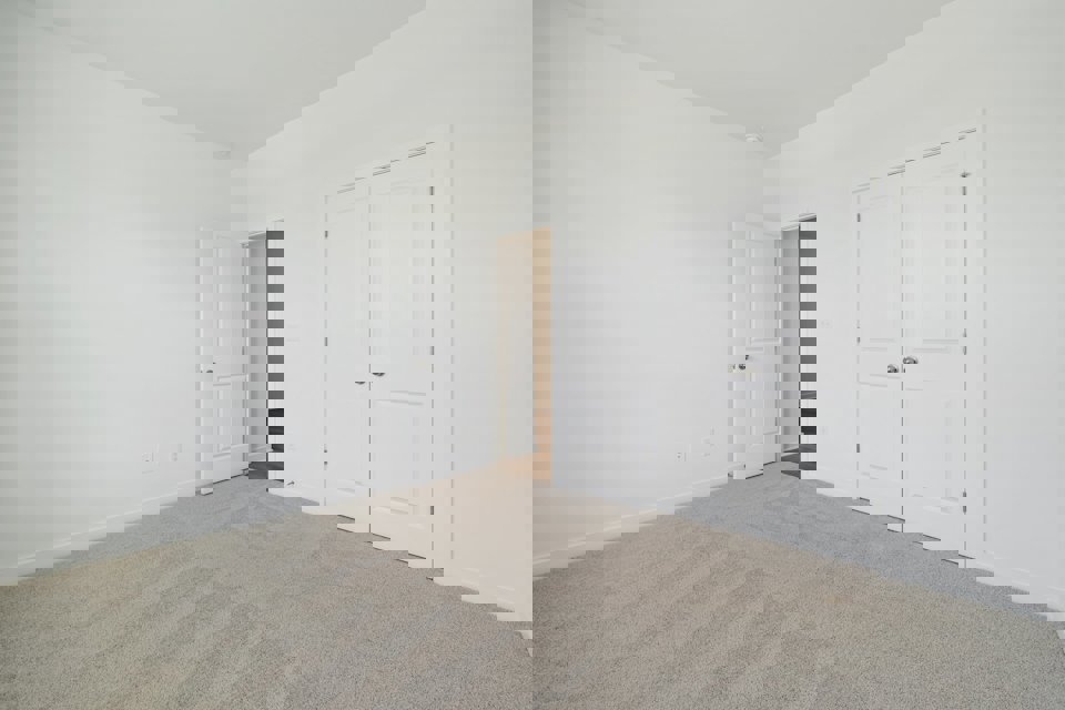 A hallway with white doors.