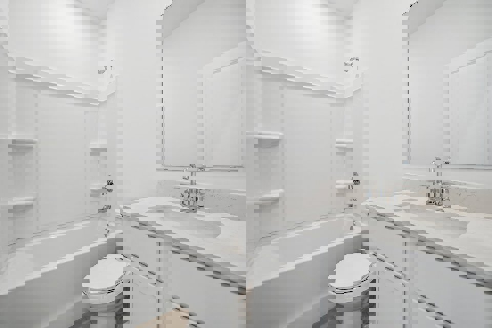 A bathroom with a tub sink and toilet.