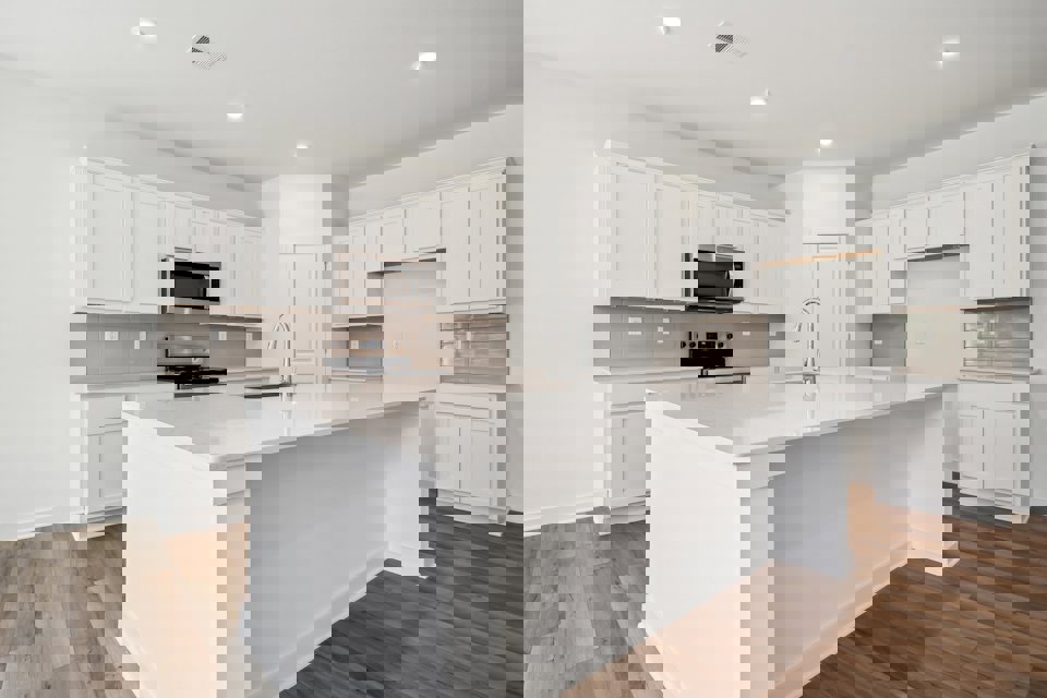 A kitchen with white cabinets.