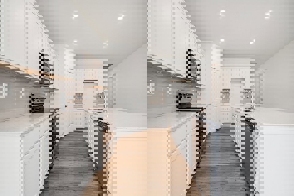 A kitchen with white cabinets.