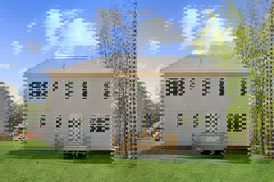A house with a bench in the front.