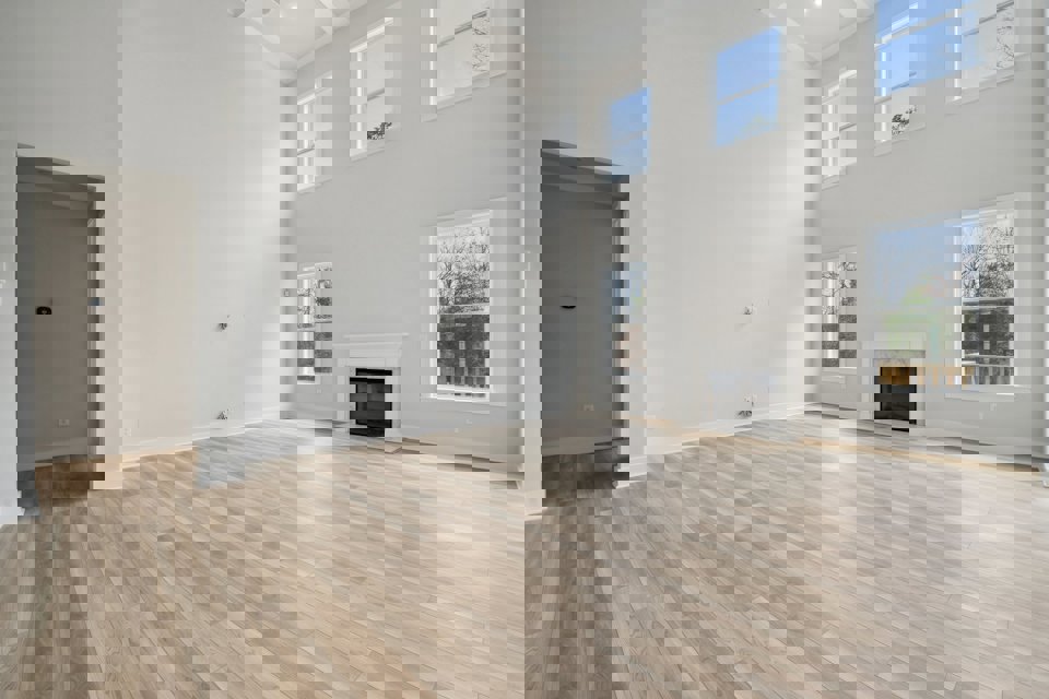 A room with a fireplace and a wood floor.