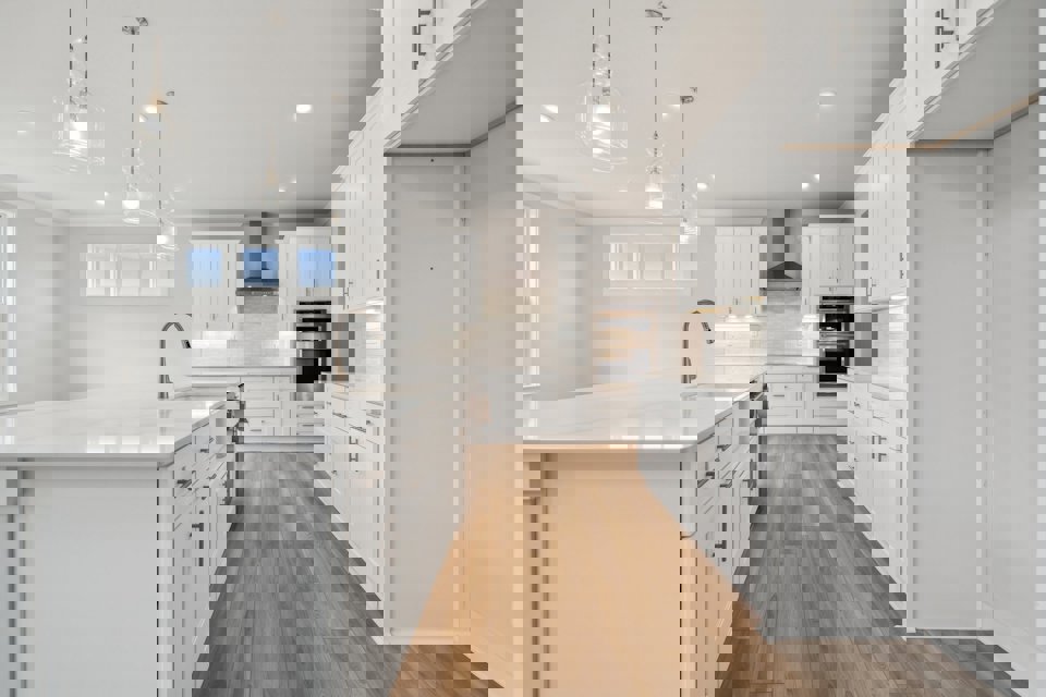 A kitchen with white cabinets.