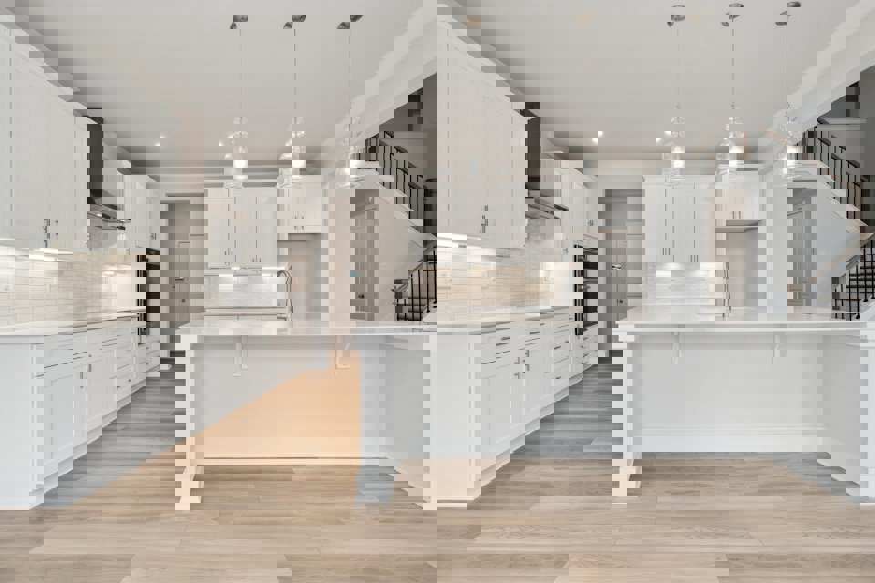 A kitchen with white cabinets.