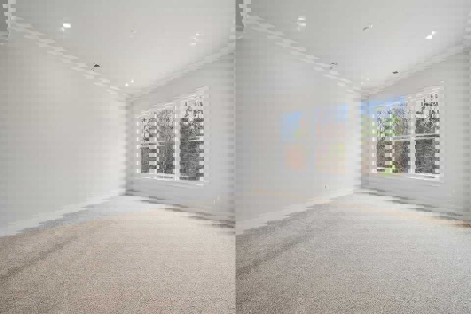 A room with a window and carpet.