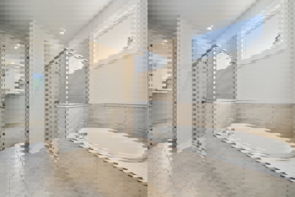A bathroom with a tub and shower.