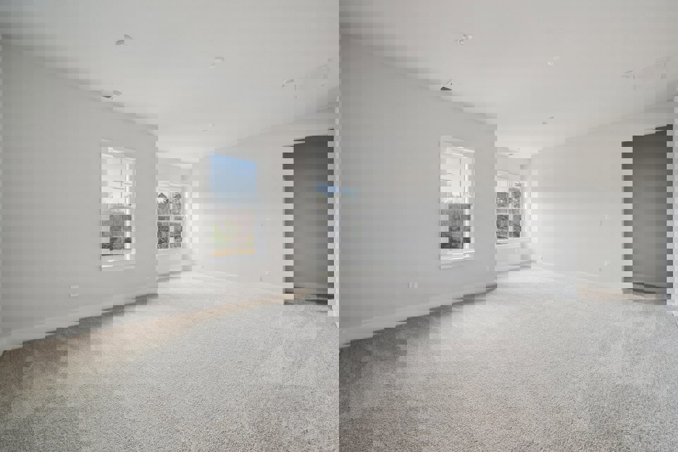 A room with a window and a carpet.