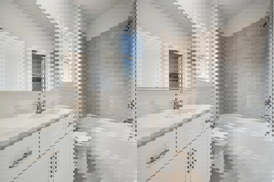 A bathroom with a tub sink and toilet.