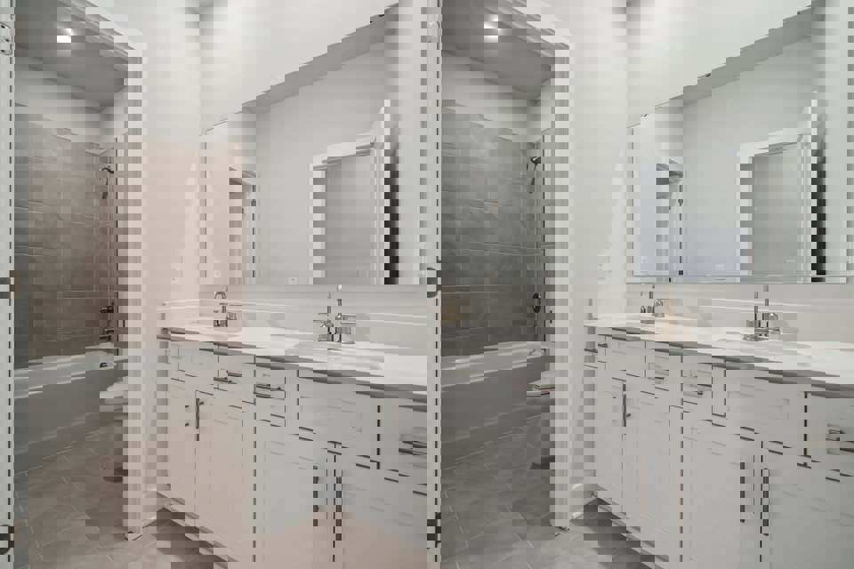 A bathroom with a tub sink and toilet.