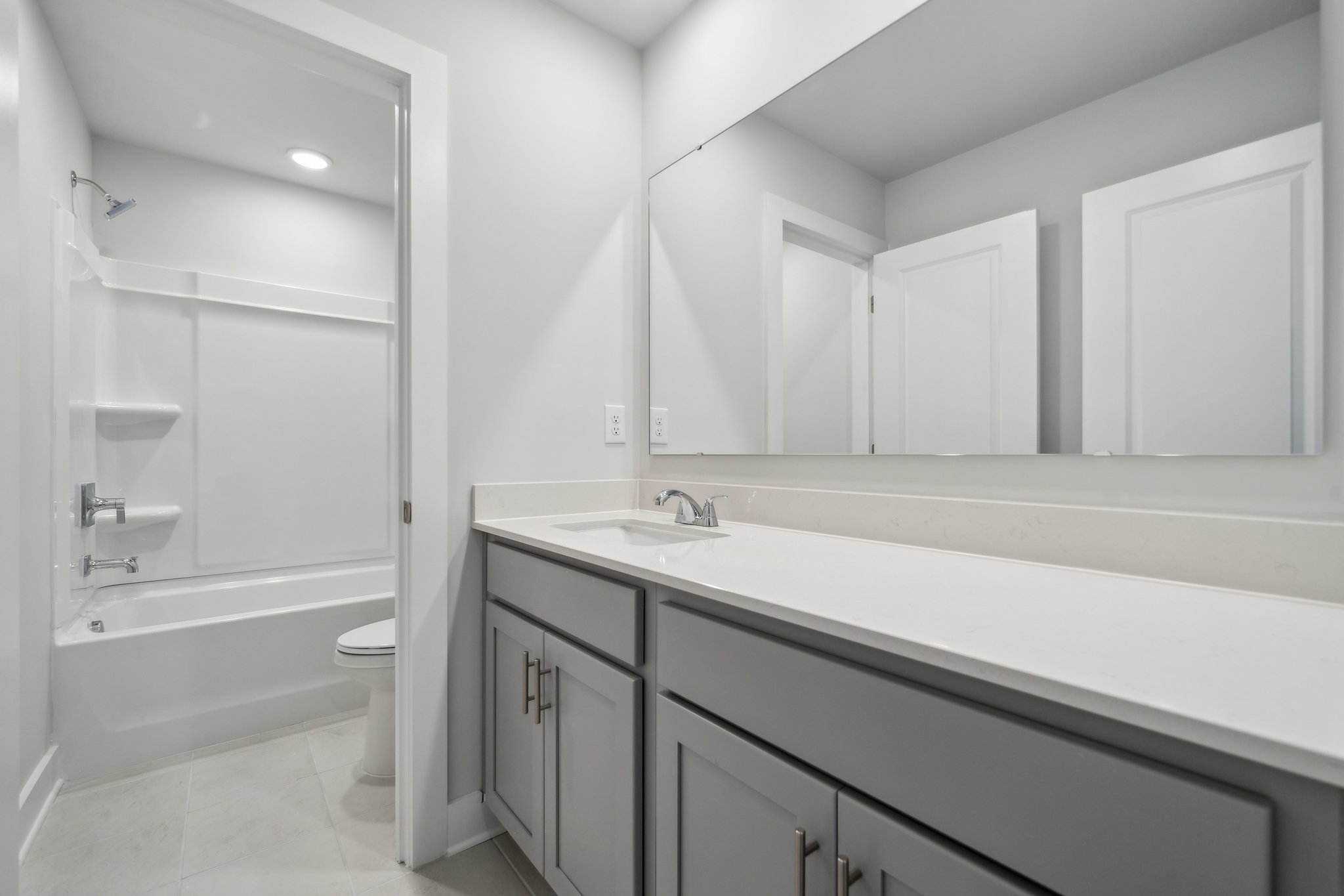 A bathroom with a tub sink and toilet.