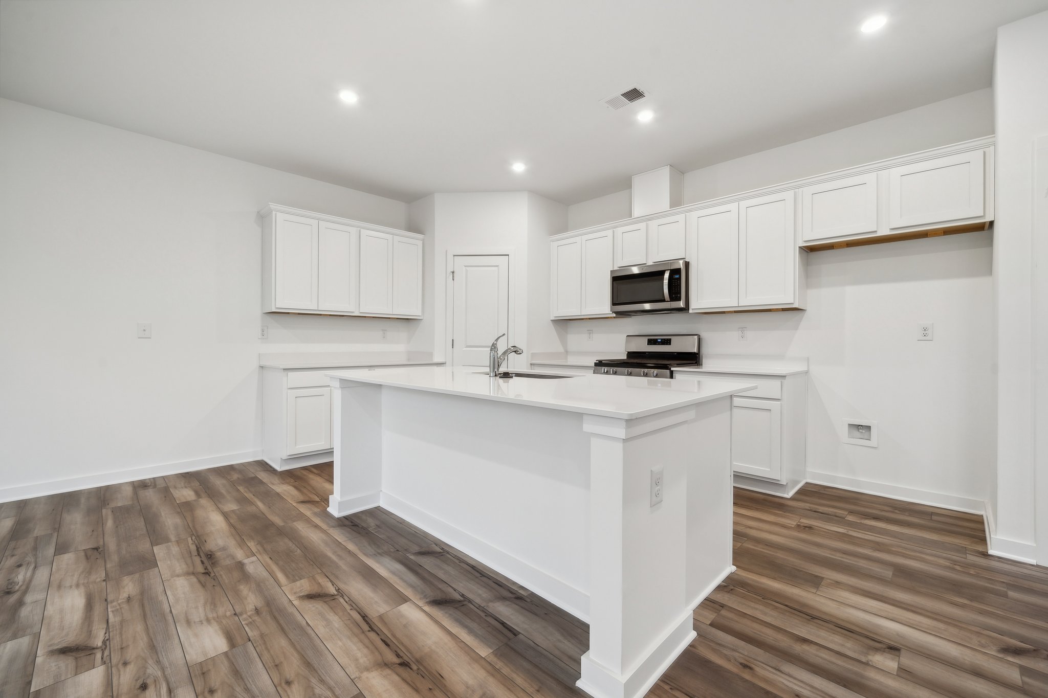A kitchen with white cabinets.