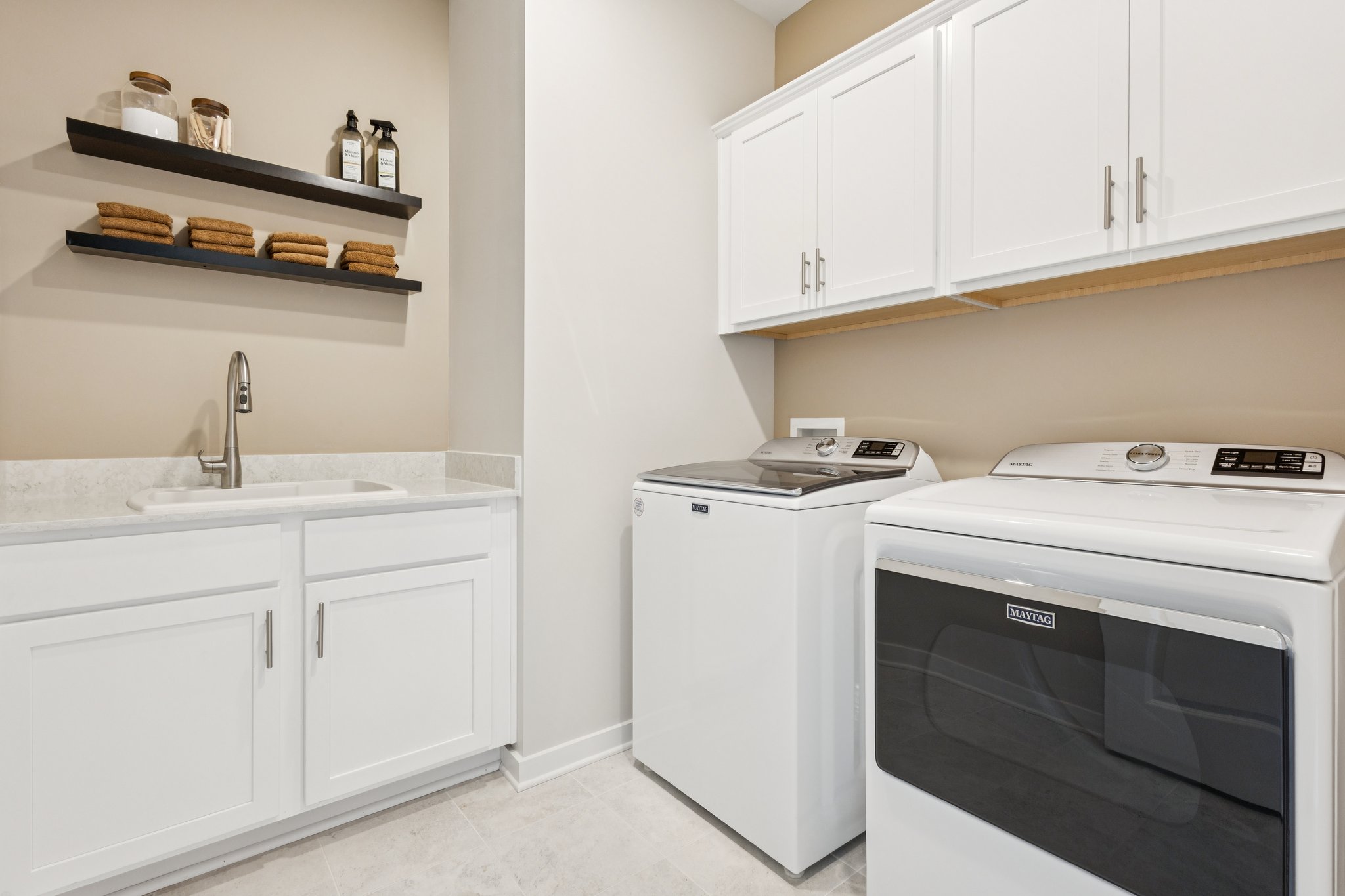 A kitchen with white cabinets.