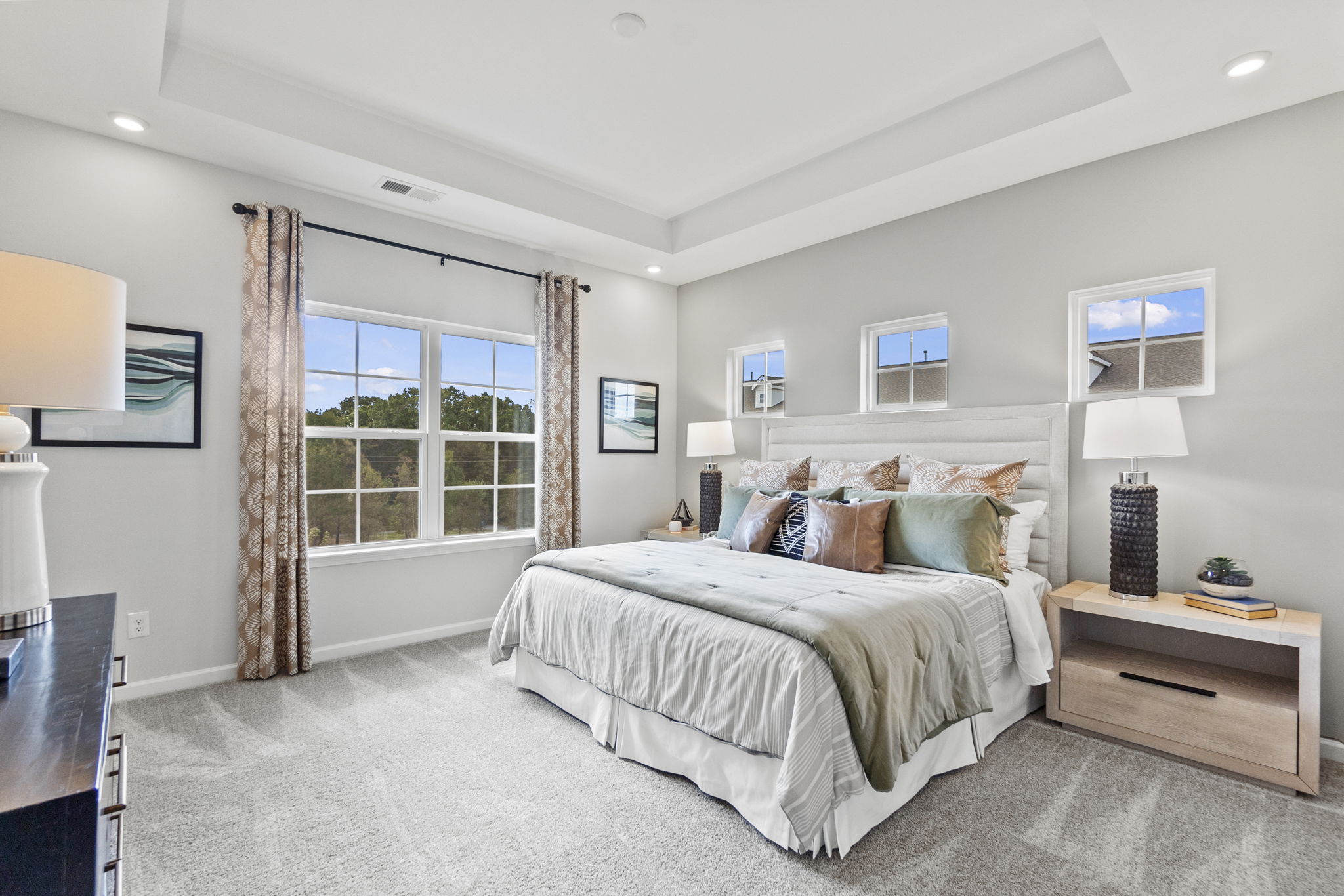 A bedroom with a large window.