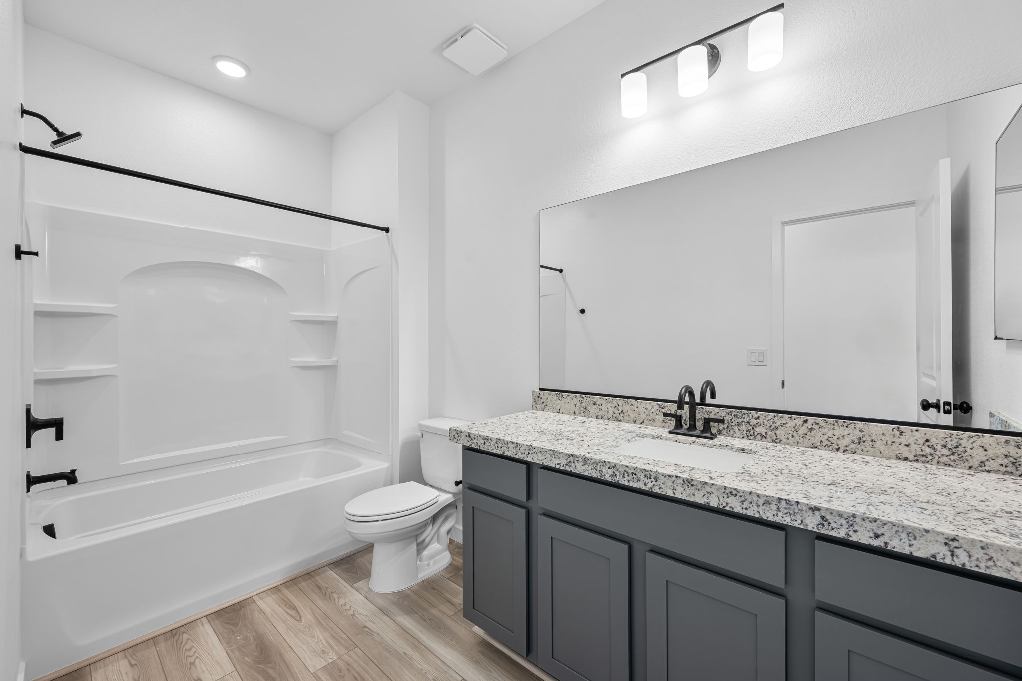 A bathroom with a large mirror.