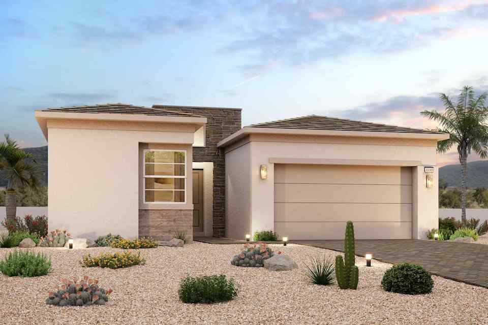 A house with a garage and a gravel driveway.