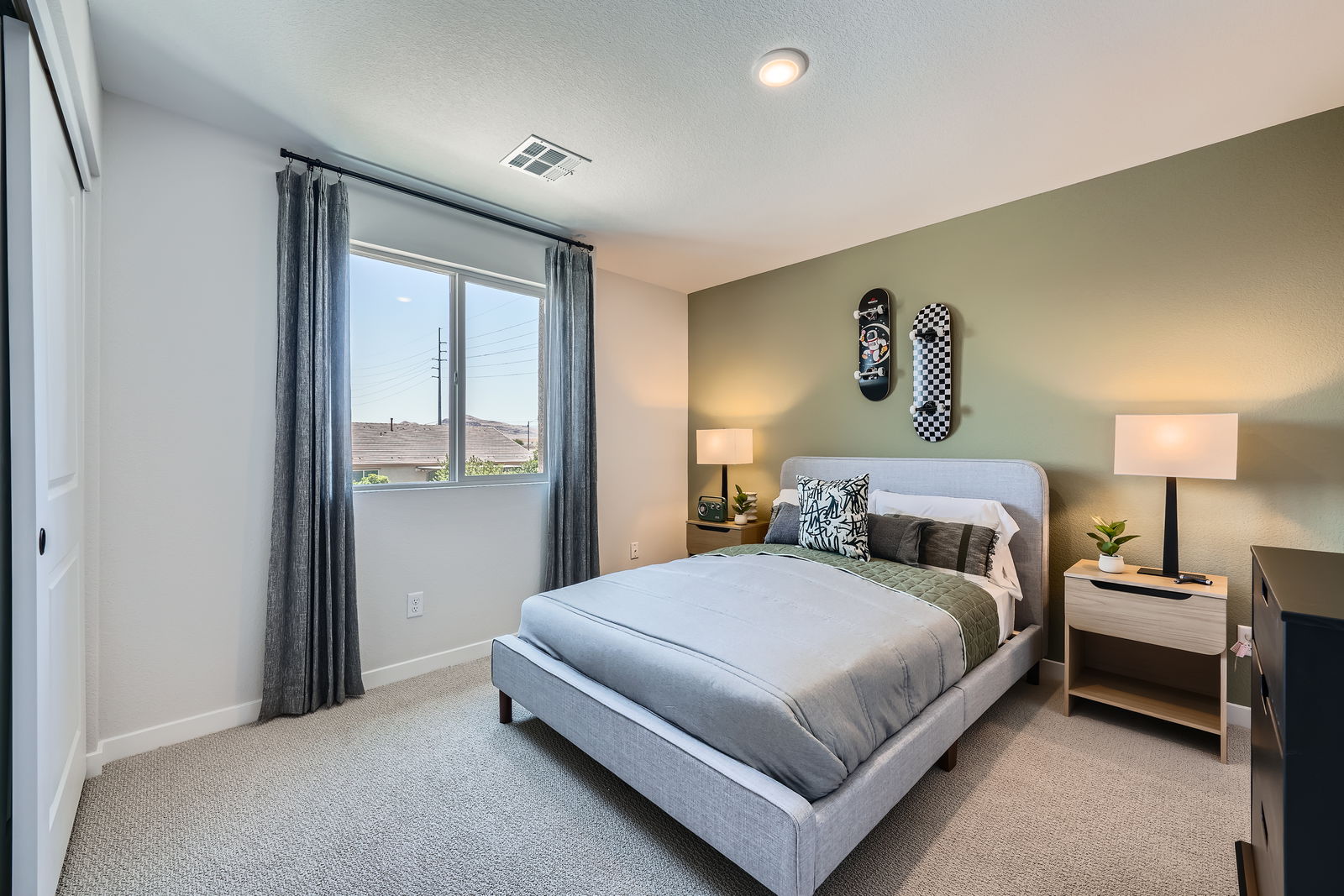 A bedroom with a bed and a window.
