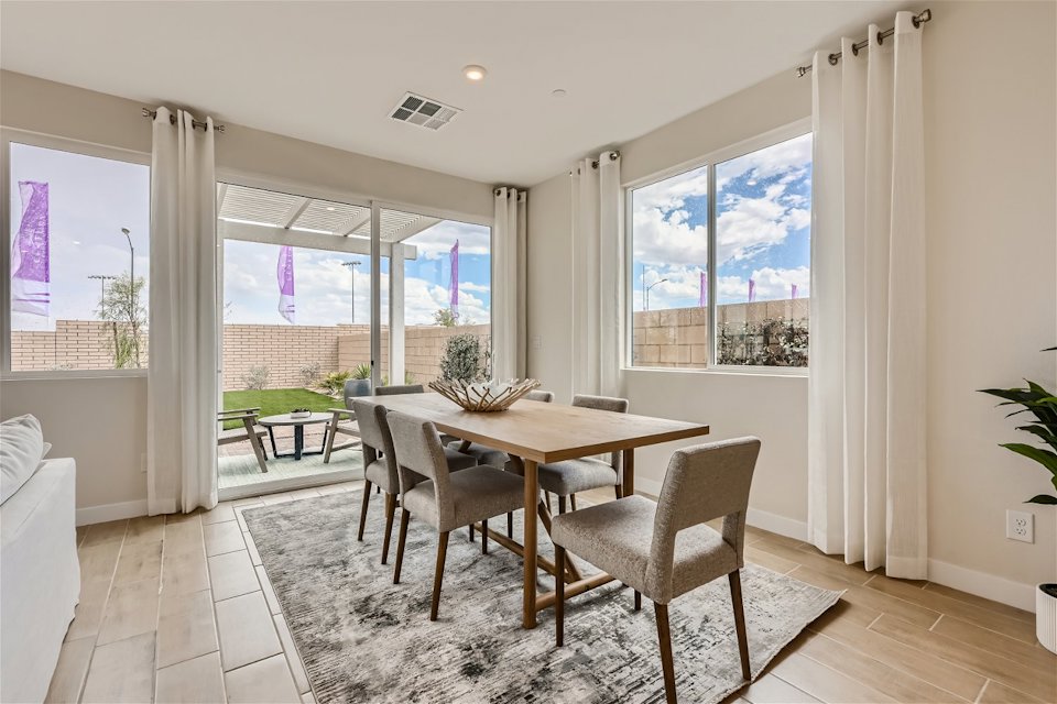 A dining room with a large window.
