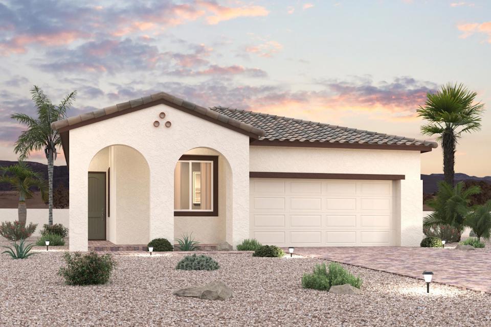 A house with a garage and palm trees.