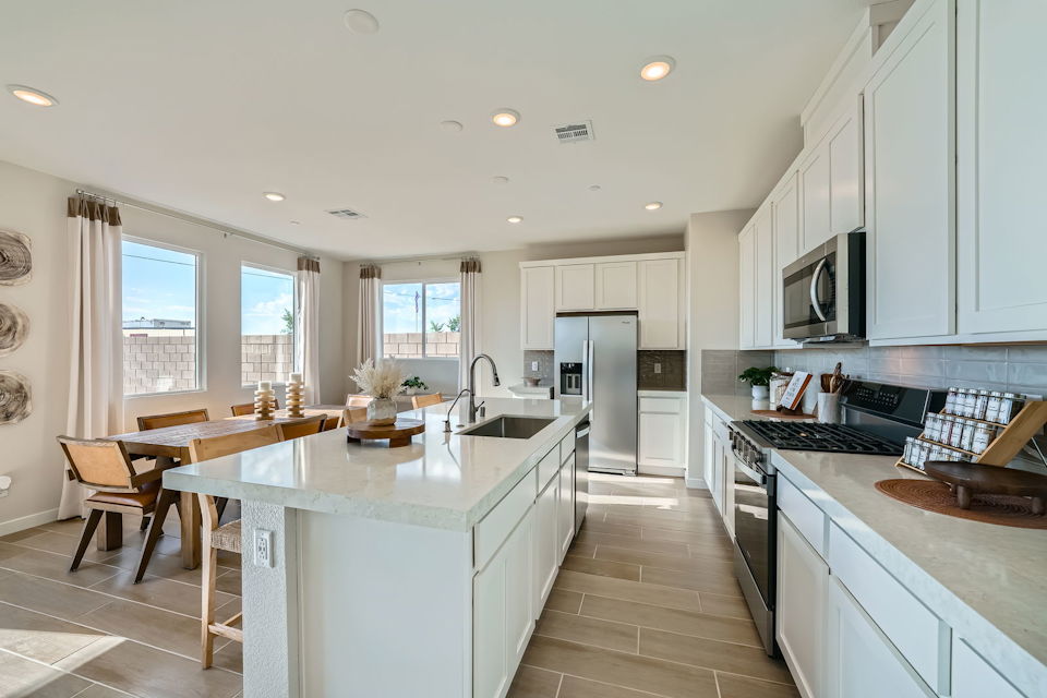 A kitchen with white cabinets.