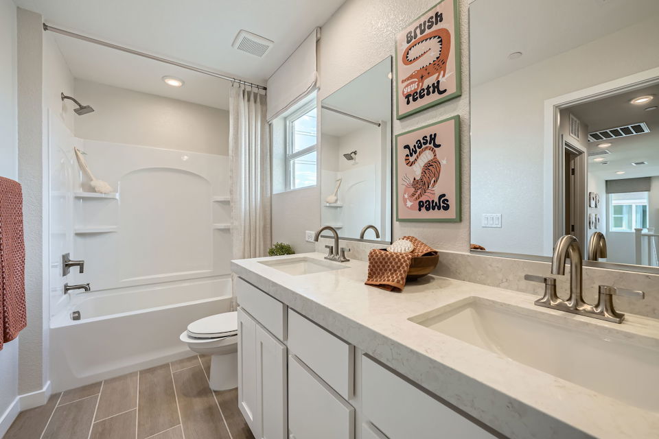 A bathroom with a tub sink and toilet.