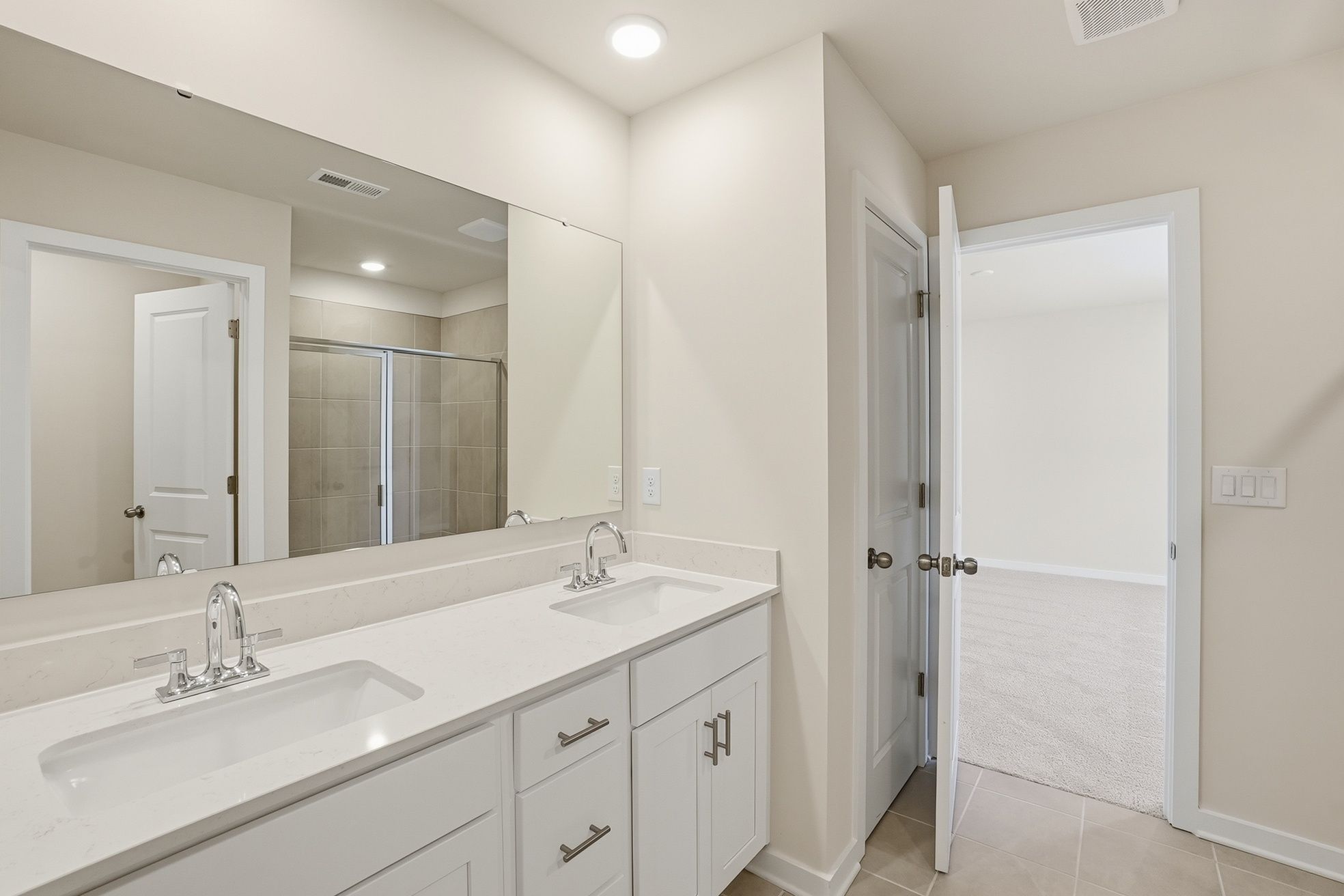 A bathroom with a large mirror.