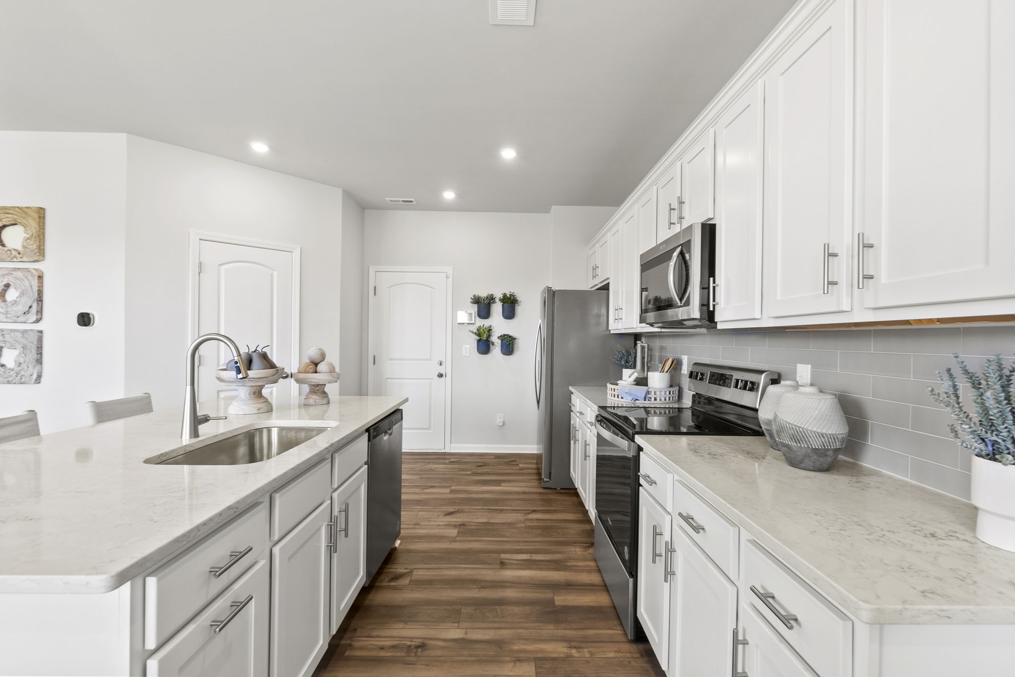 A kitchen with white cabinets.
