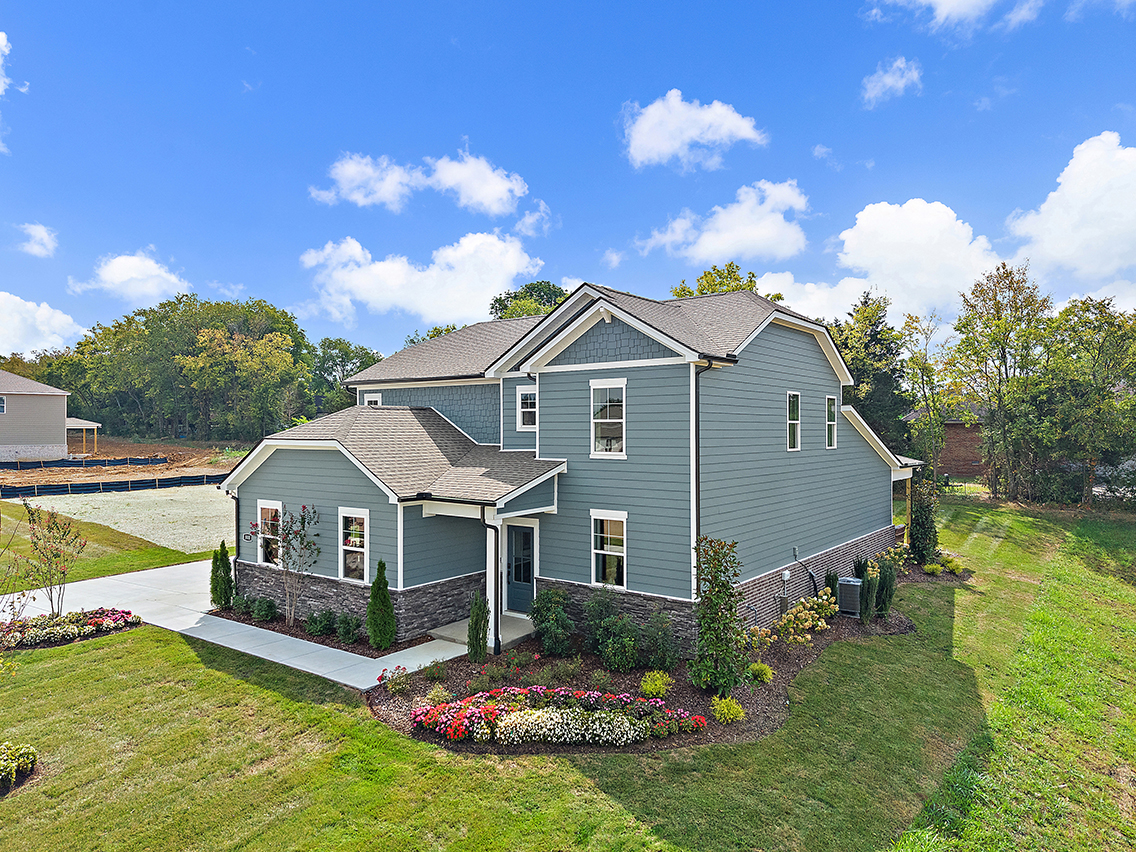 A house with a garden in the front.