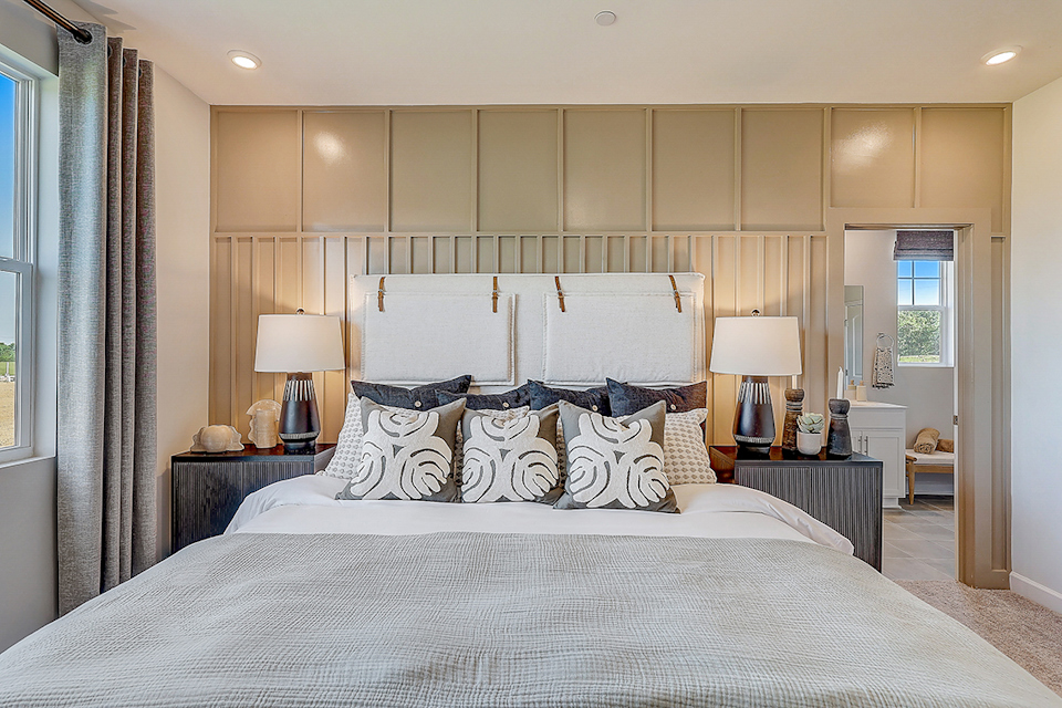 A bedroom with a bed and lamps.