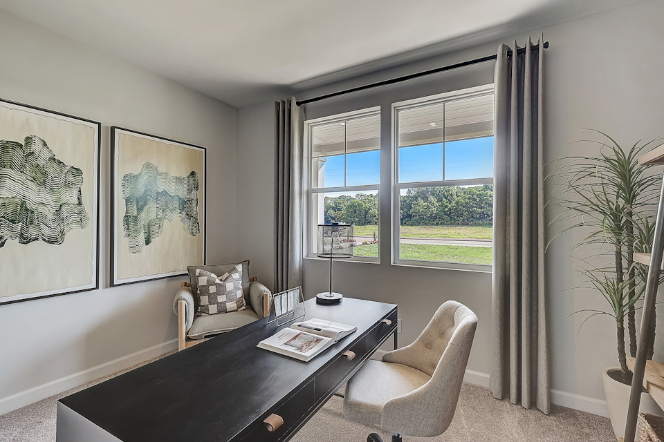 A bedroom with a large window.
