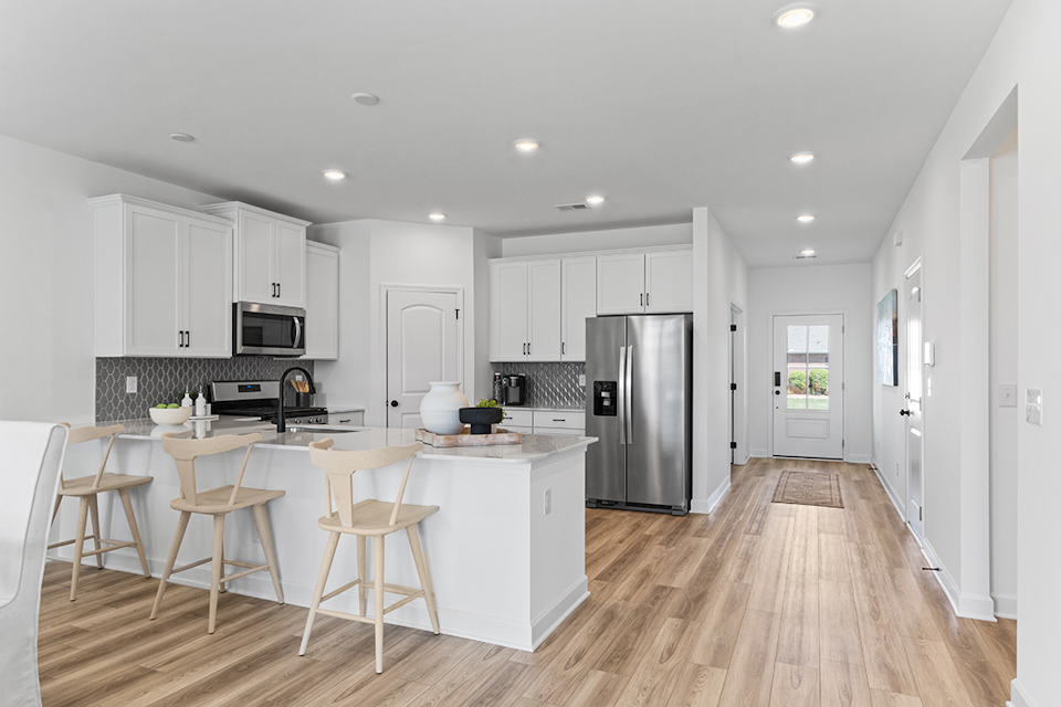 A kitchen with white cabinets.
