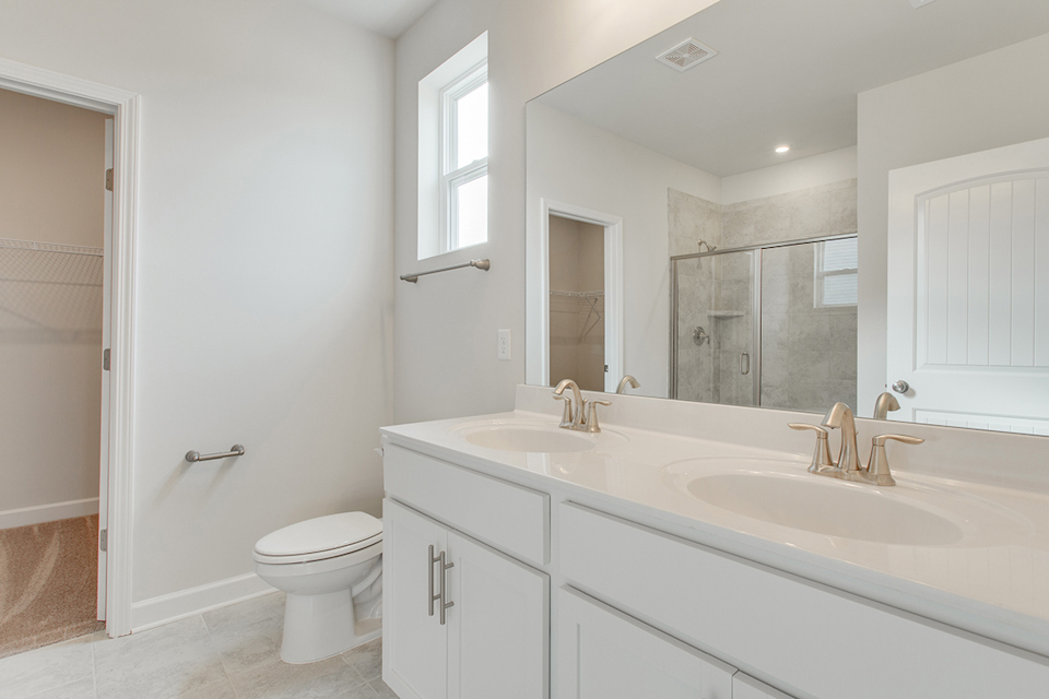 A bathroom with a tub sink and toilet.