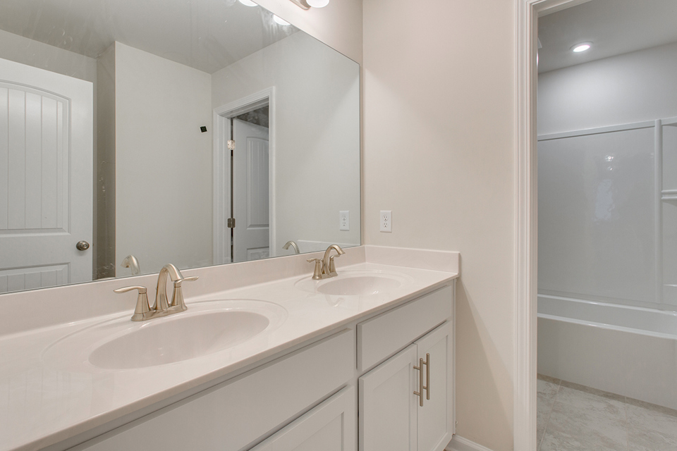 A bathroom with a sink and a mirror.
