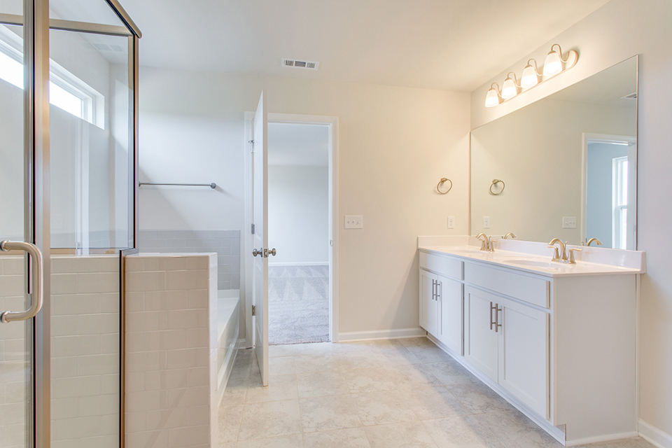 A bathroom with a shower and sink.