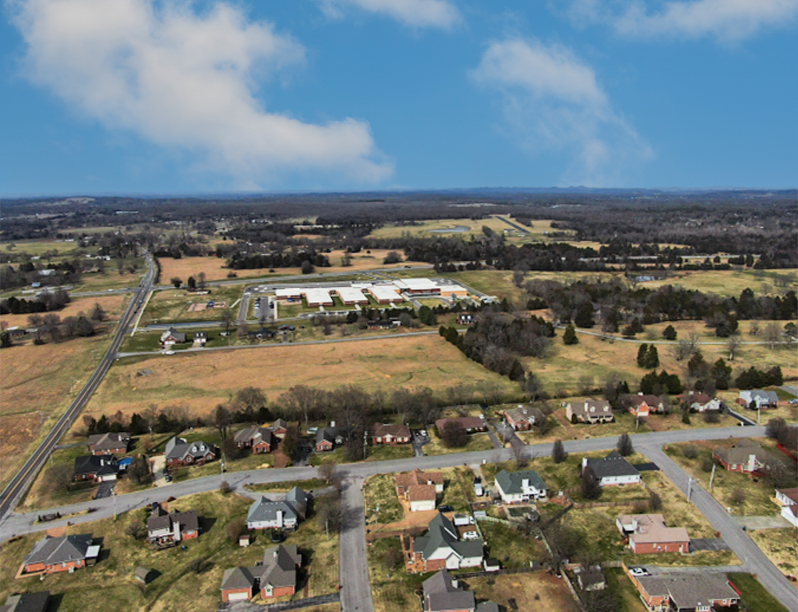 A landscape with houses and trees.
