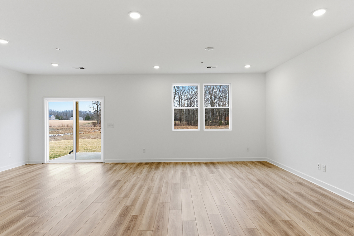 A room with a wood floor and windows.