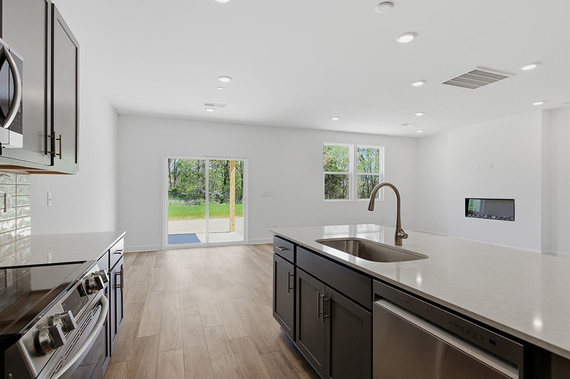 A kitchen with a wood floor.