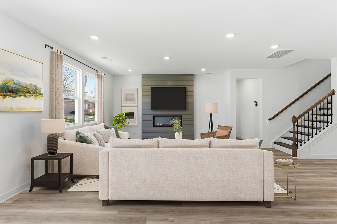 A living room with a large staircase.