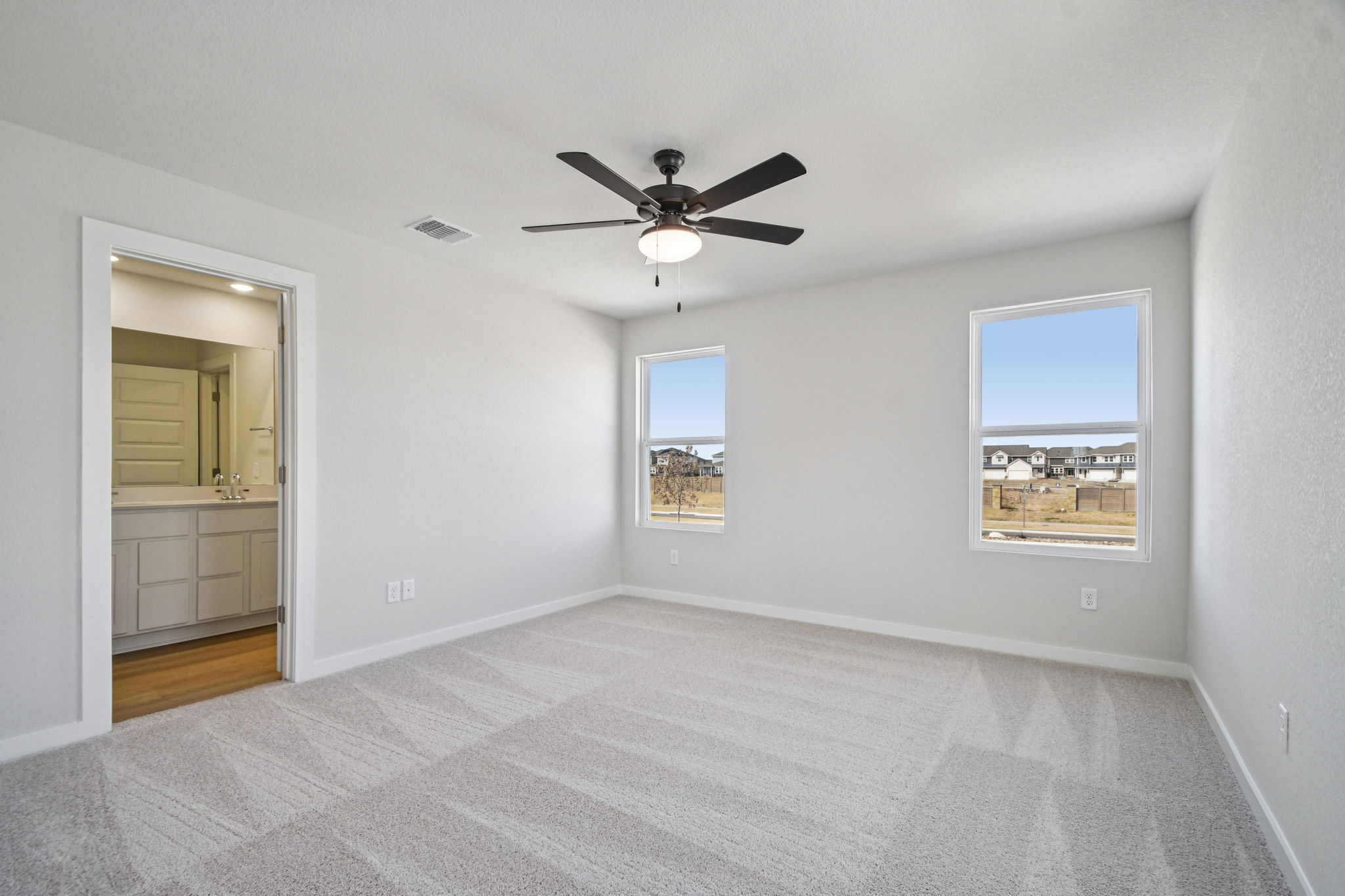 A room with a ceiling fan and a window.