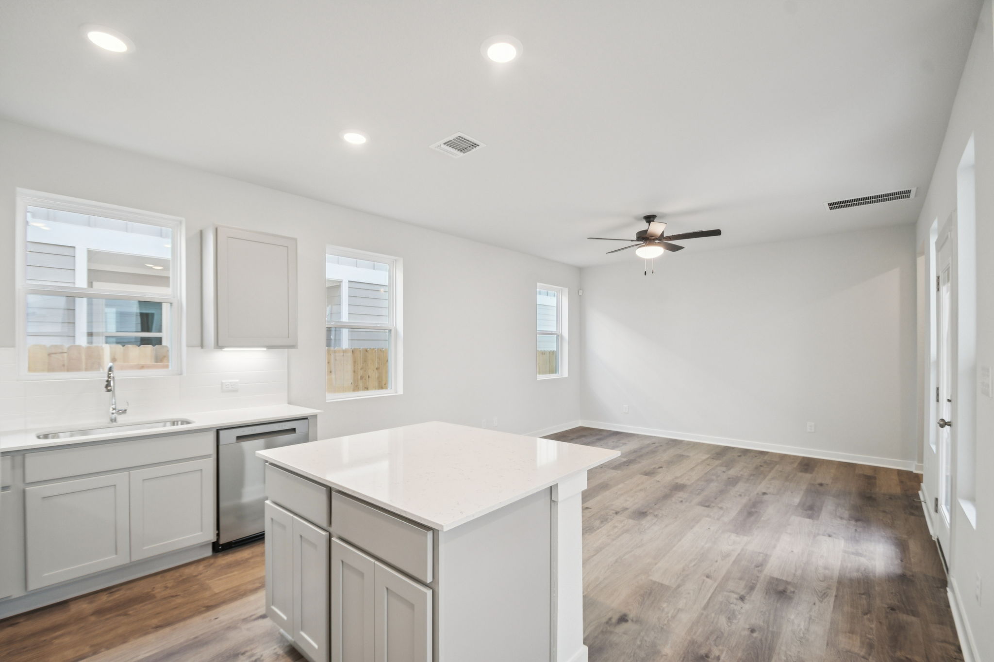 A kitchen with white cabinets.