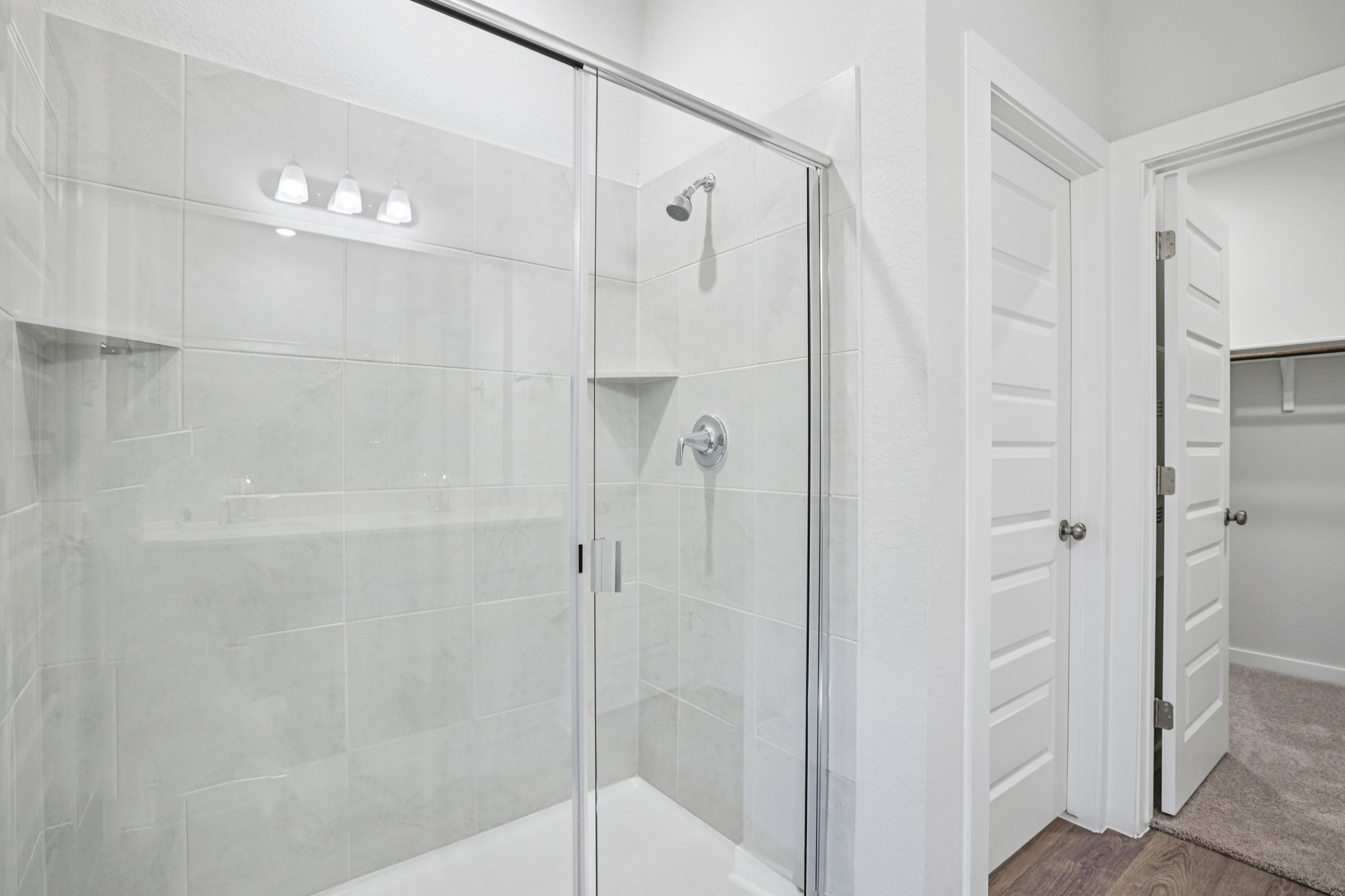 A shower with glass doors.