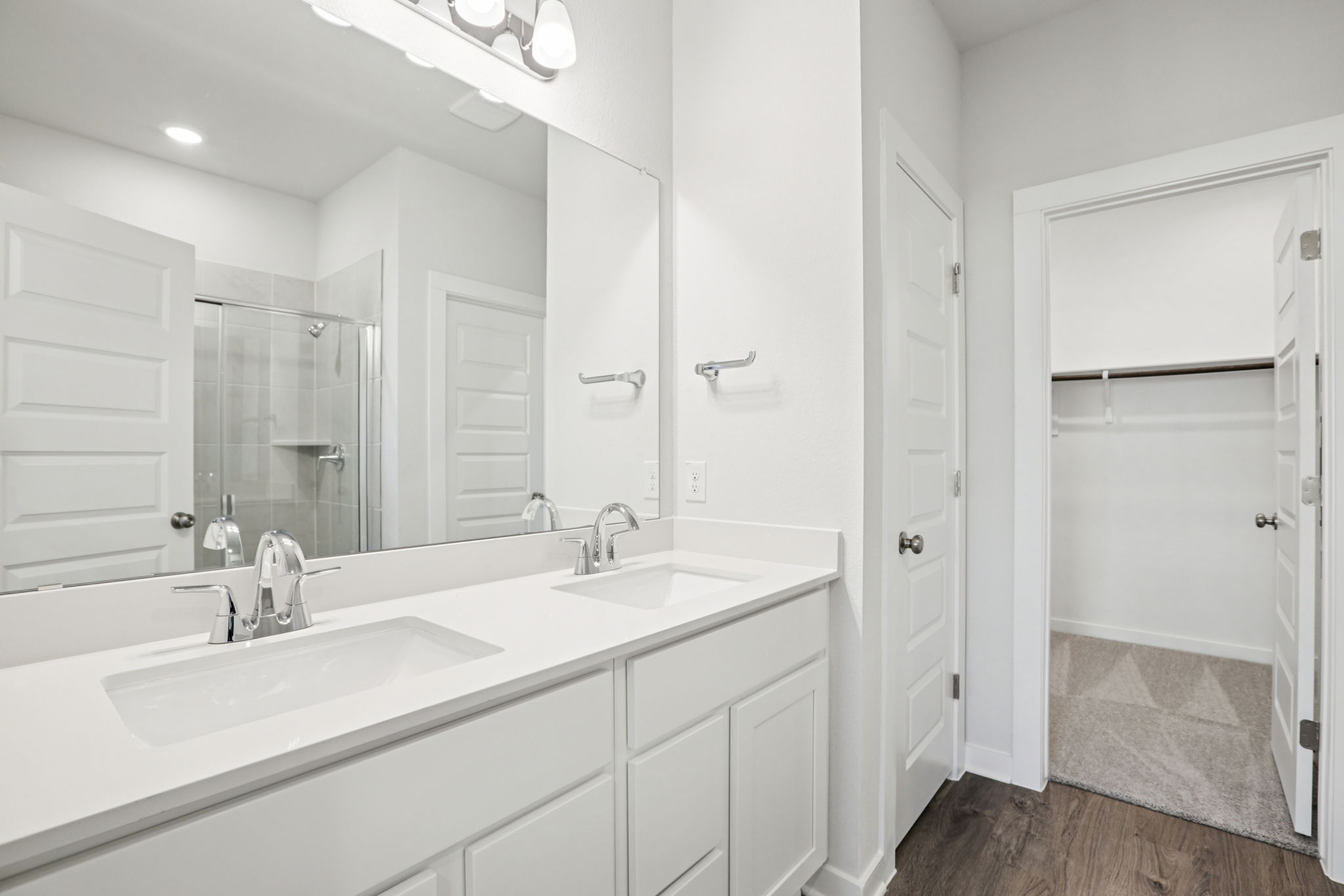 A bathroom with white cabinets.