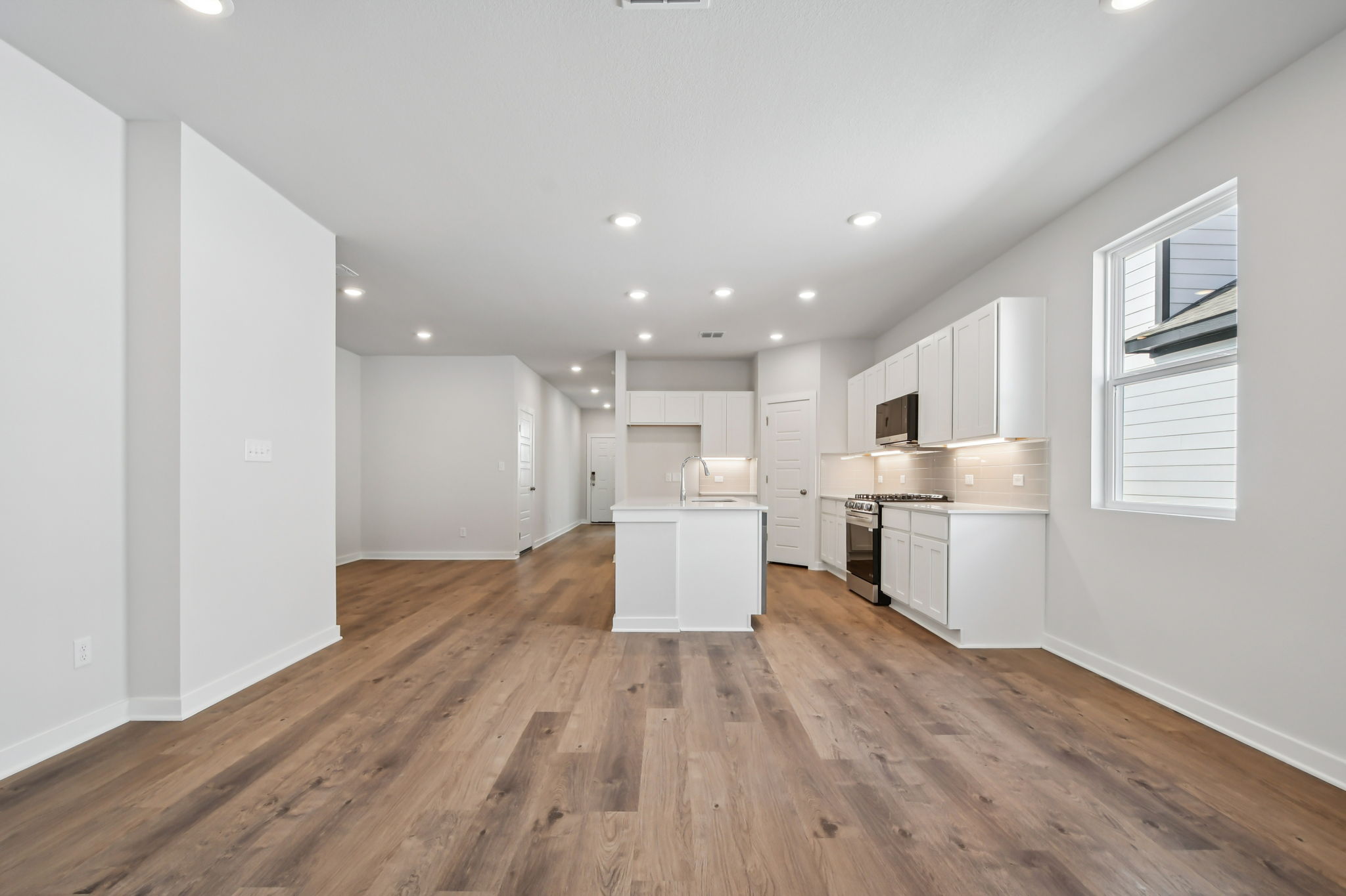 A large kitchen with white cabinets.