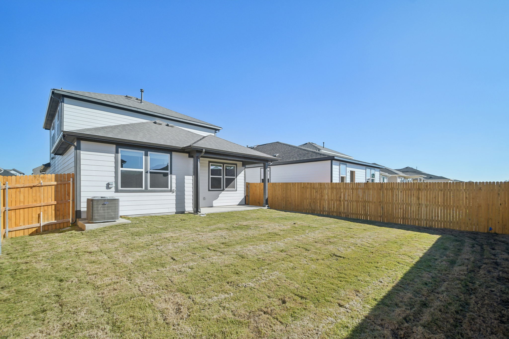 A house with a fence and grass.