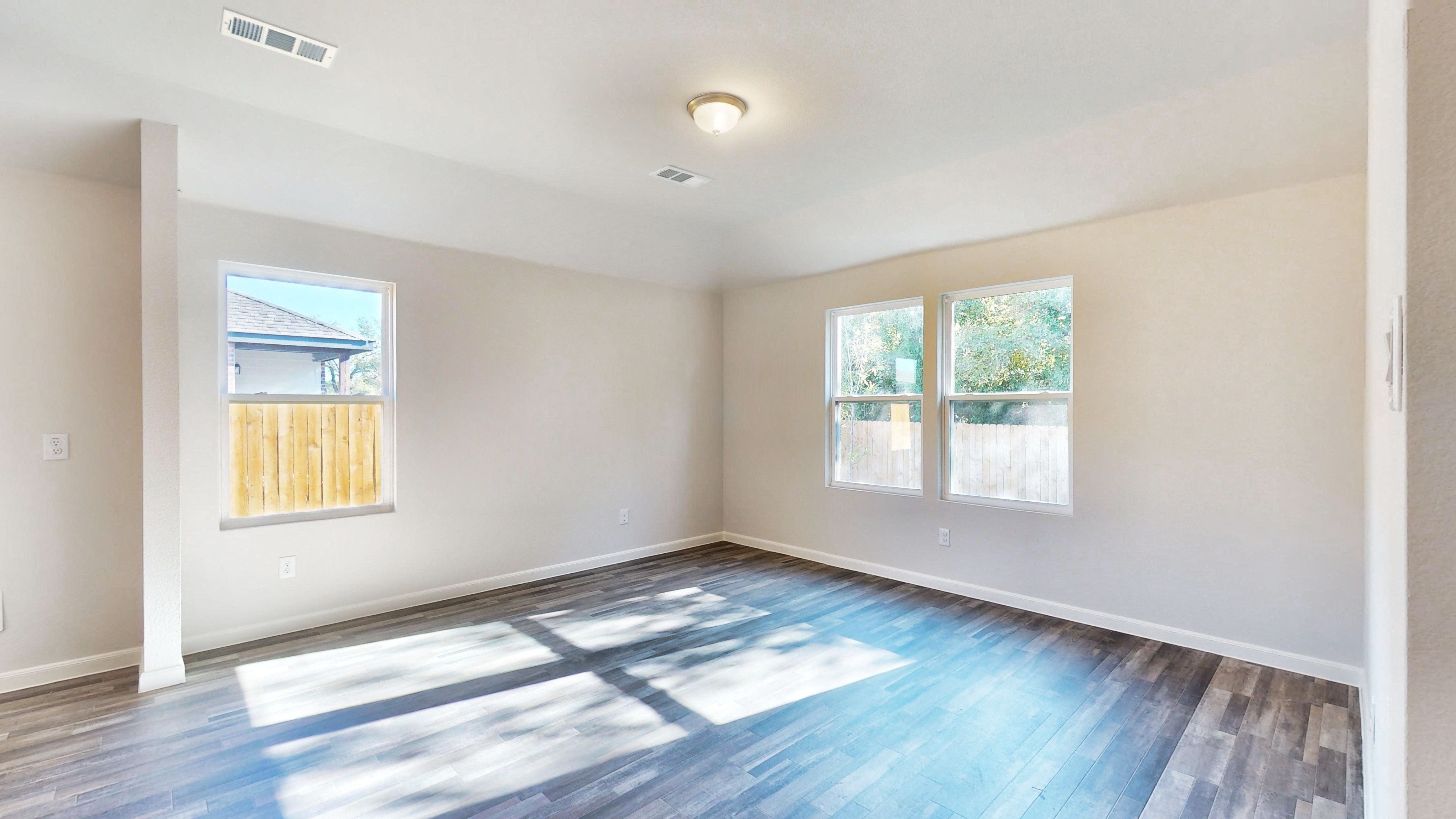 A room with a blue floor and windows.
