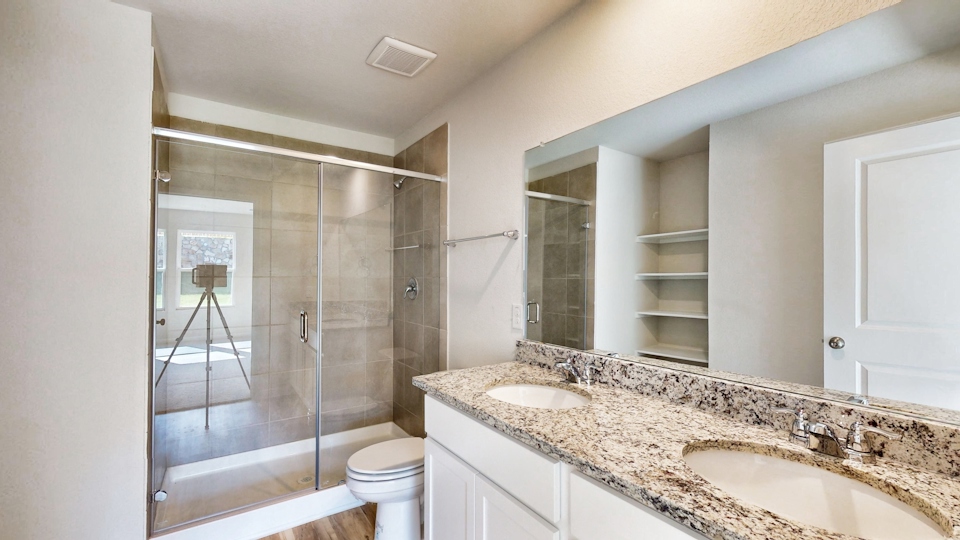 A bathroom with a glass shower.