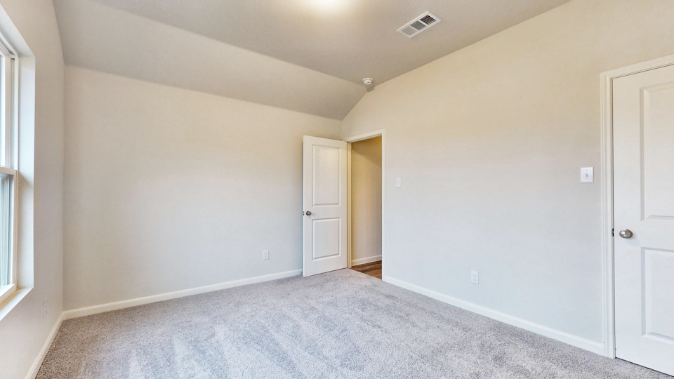 A hallway with white doors.