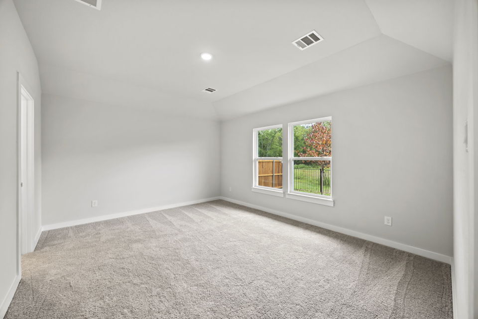 A room with a window and a carpet.